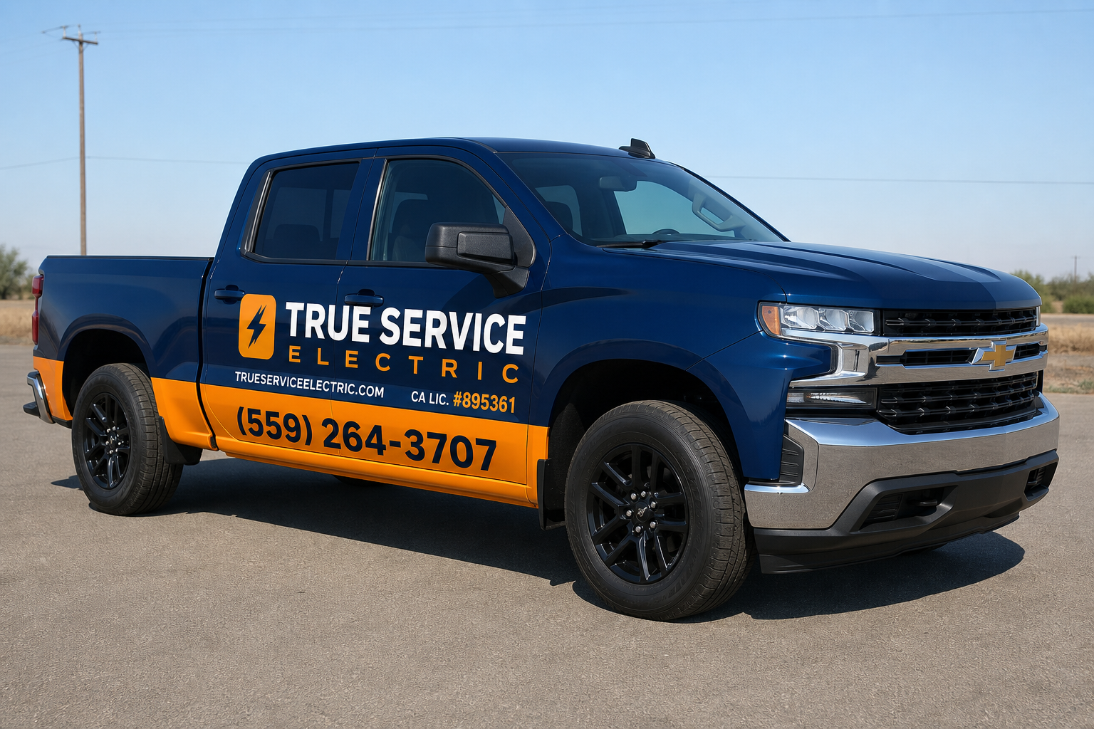 A dark blue and orange Chevrolet pickup truck with True Service Electric lettering, parked under a clear sky.